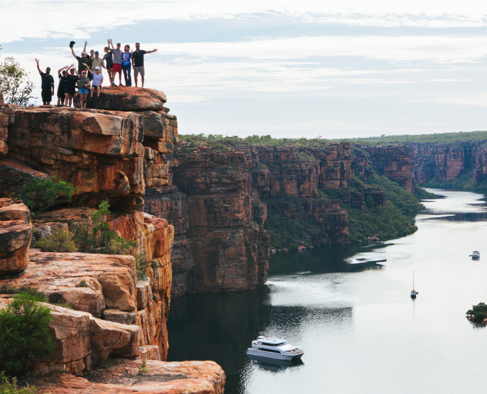group of people on the edge of a cliff