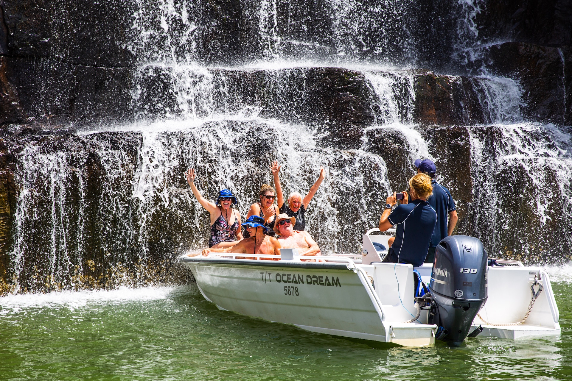 Small boat by a waterfall in the Kimberley