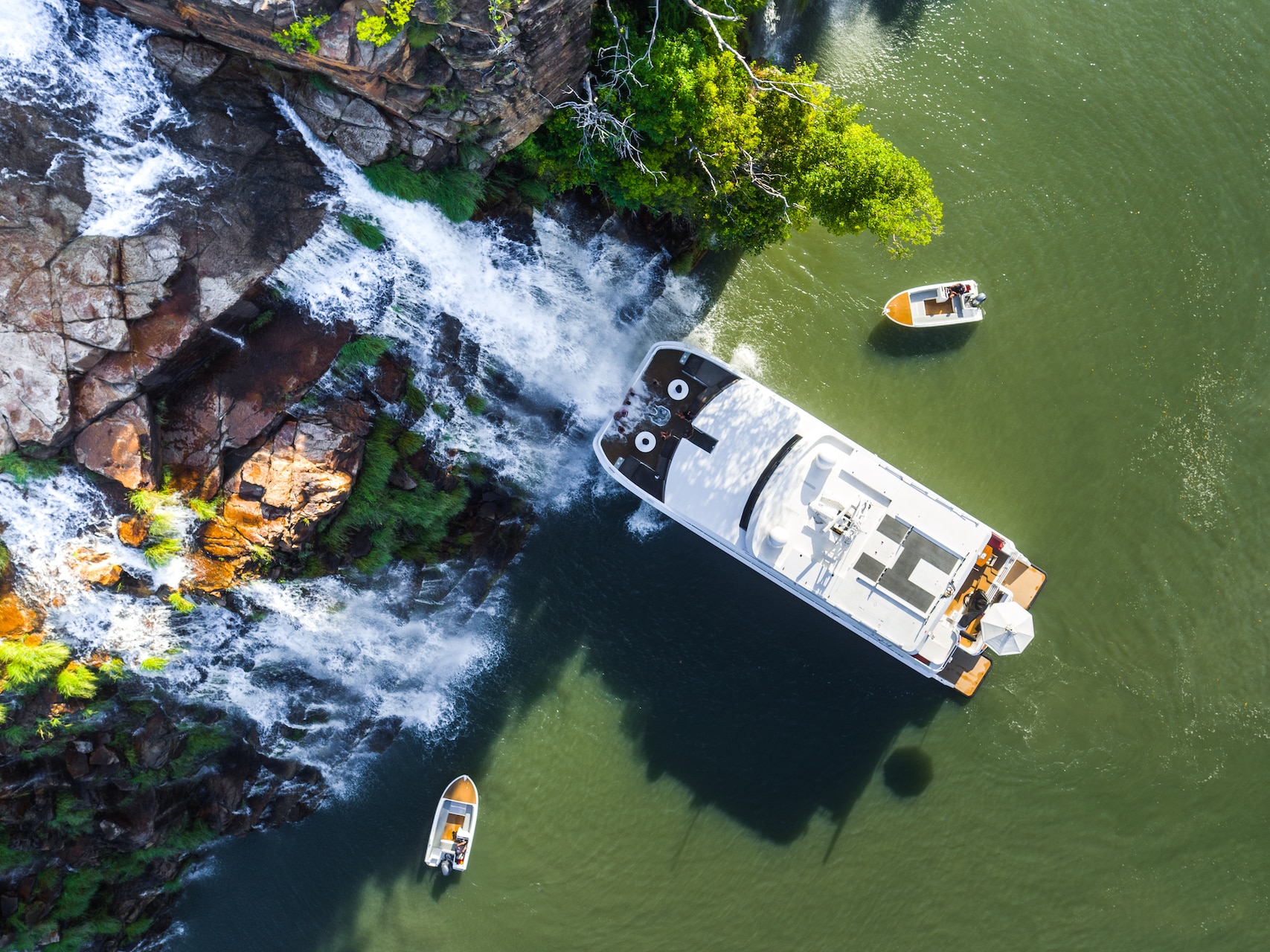 Kimberley cruise ship next to waterfall