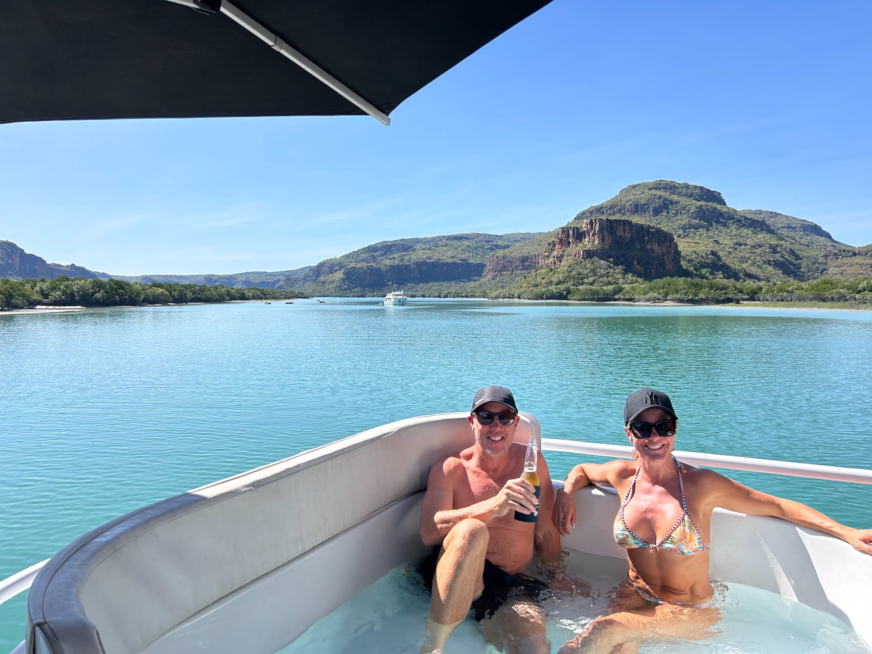 Couple having a beer in the jacuzzi on ocean dream cruise boat